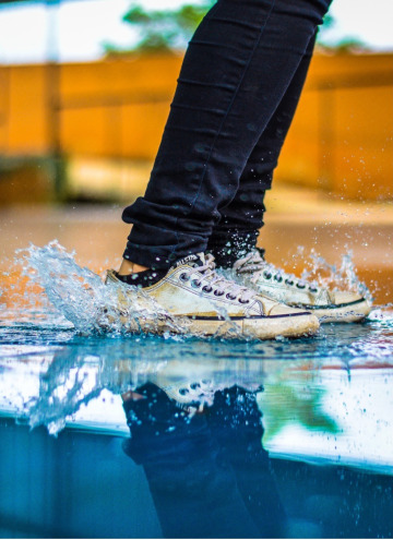 feet splashing in puddle